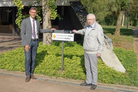 2 Männer vor Schild